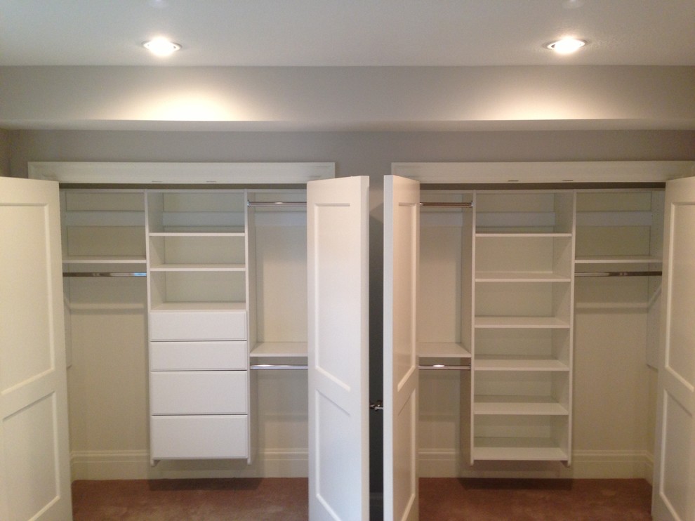 This is an example of a mid-sized traditional men's built-in wardrobe in Salt Lake City with white cabinets, open cabinets and brown floor.