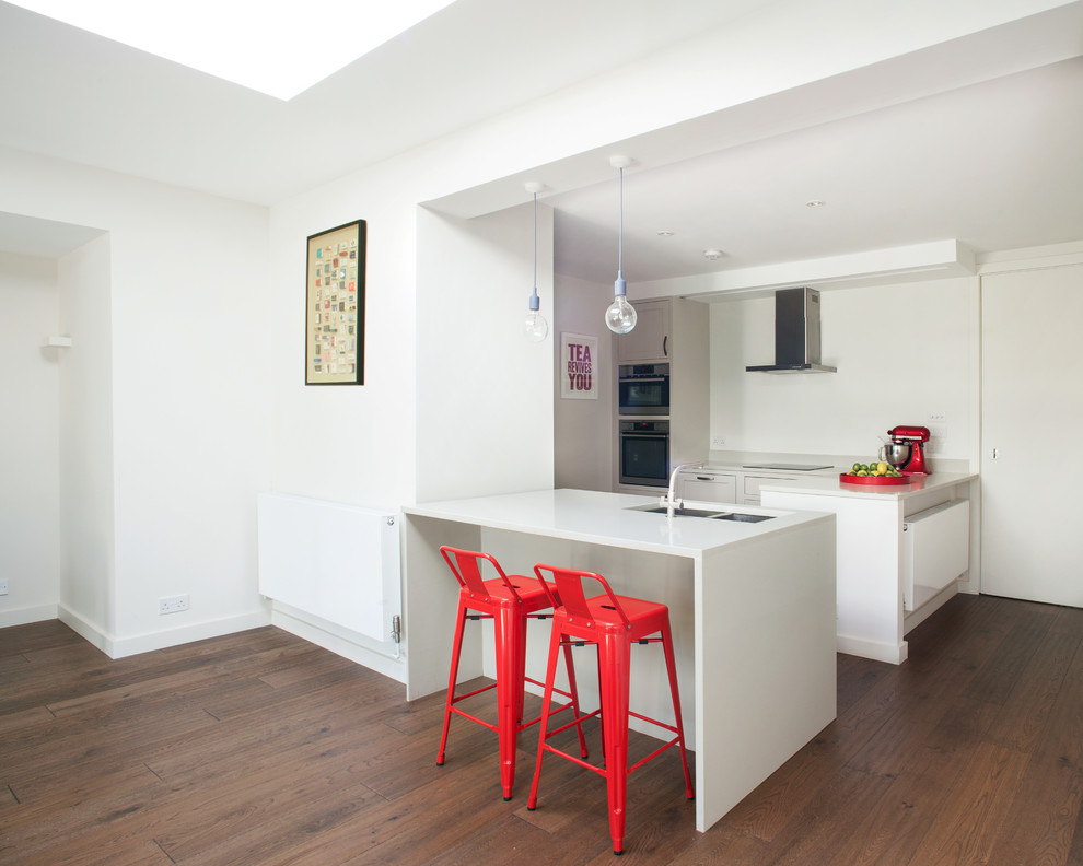 Design ideas for a mid-sized contemporary kitchen in London with medium hardwood floors.