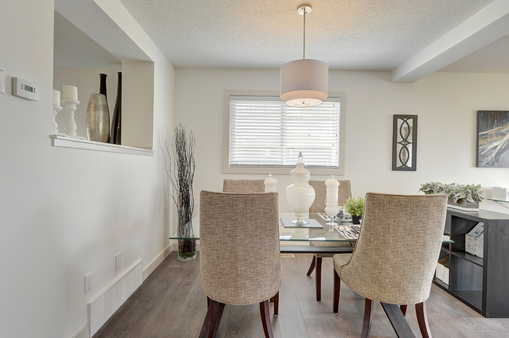Inspiration for a mid-sized transitional laminate floor and gray floor kitchen/dining room combo remodel in Edmonton with white walls and no fireplace