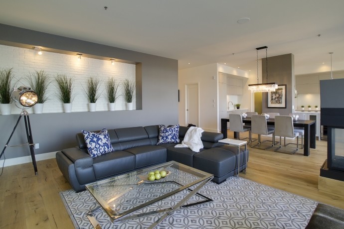 Mid-sized contemporary formal open concept living room in Montreal with grey walls, light hardwood floors, a corner fireplace, a built-in media wall, a metal fireplace surround and beige floor.