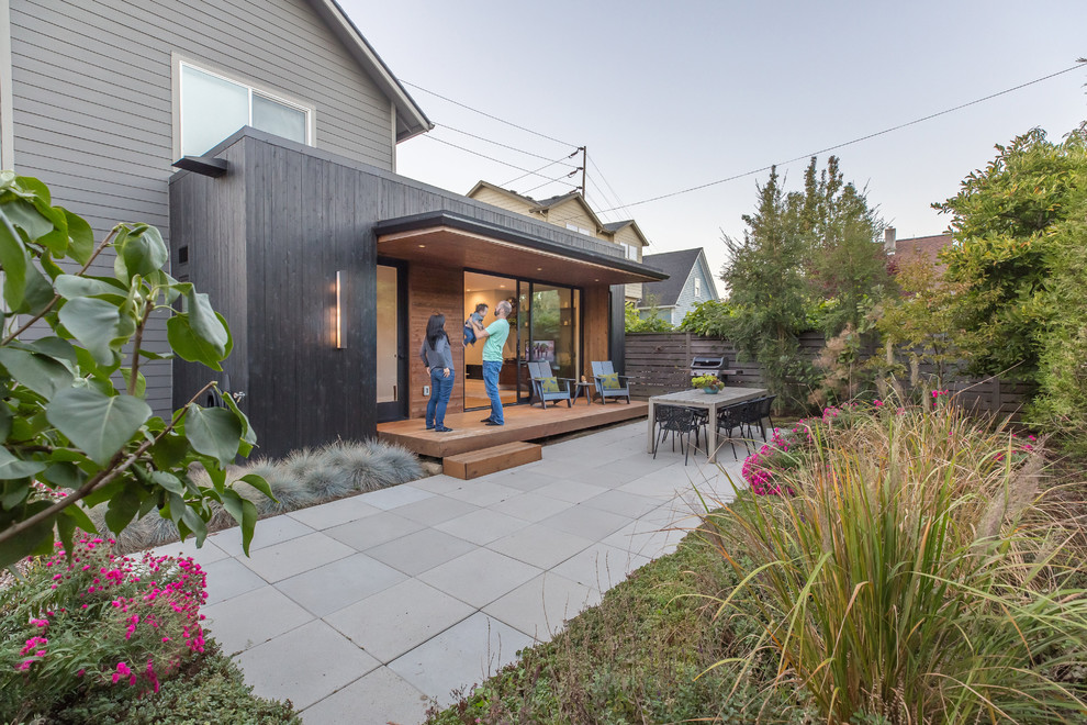 Inspiration for a small modern courtyard patio in Portland with an outdoor kitchen, a roof extension and concrete pavers.