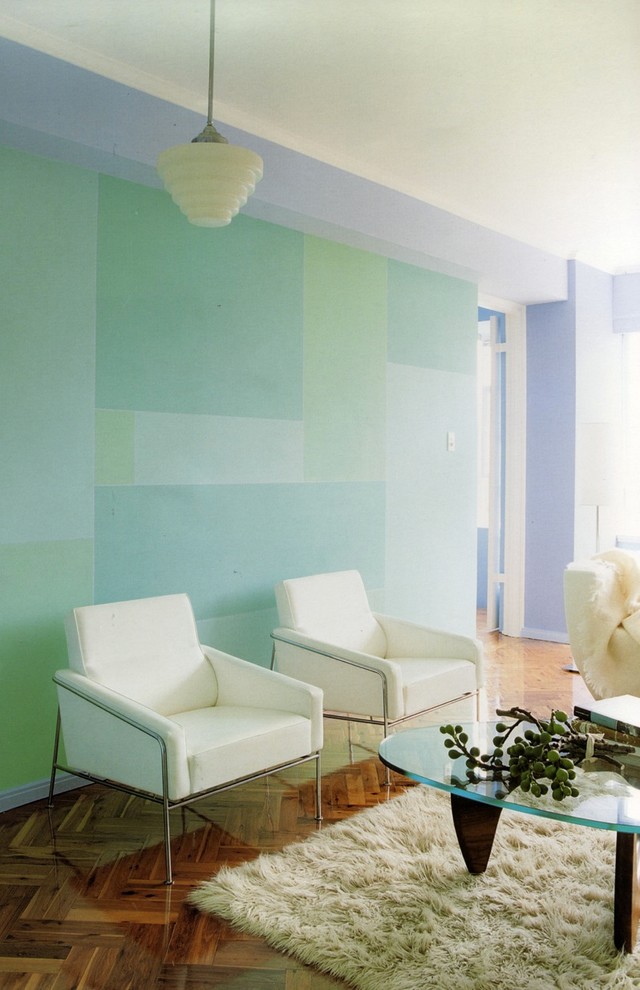 This is an example of a contemporary living room in Sydney with blue walls and medium hardwood floors.