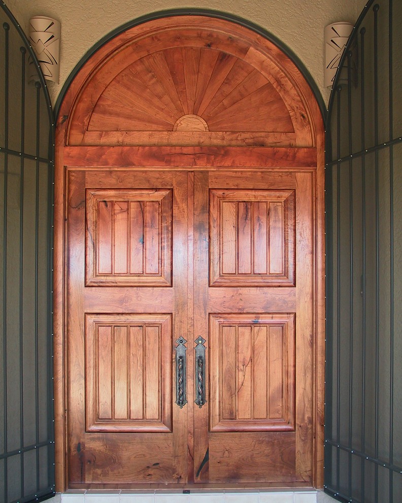 Design ideas for a large traditional front door in Phoenix with beige walls, travertine floors, a double front door and a medium wood front door.
