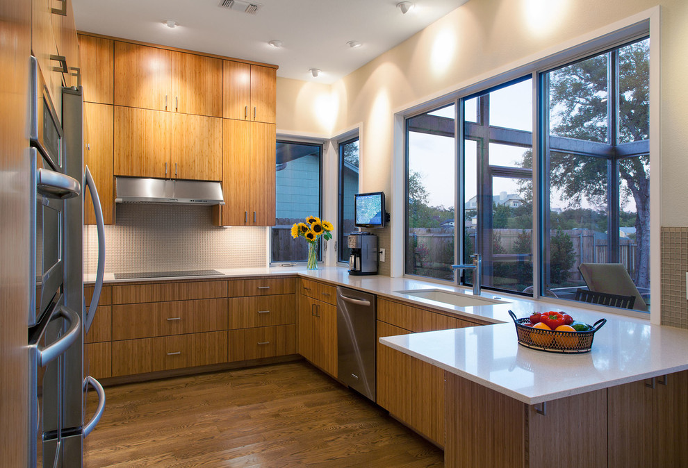 This is an example of a contemporary kitchen in Austin with flat-panel cabinets.