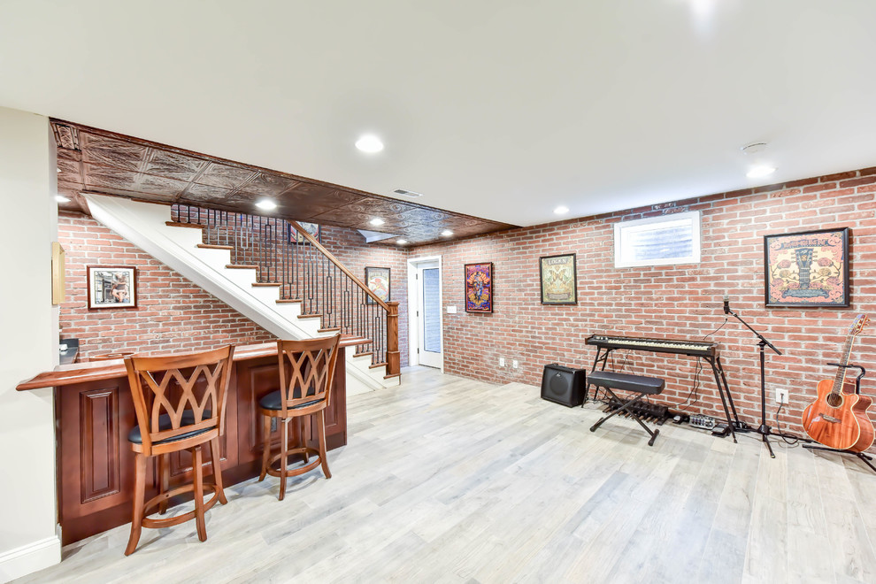 Design ideas for a mid-sized traditional walk-out basement with white walls, light hardwood floors and grey floor.