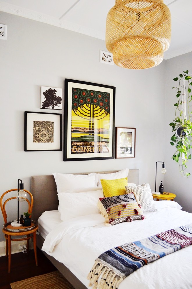 This is an example of a mid-sized eclectic guest bedroom in Perth with grey walls, dark hardwood floors and brown floor.