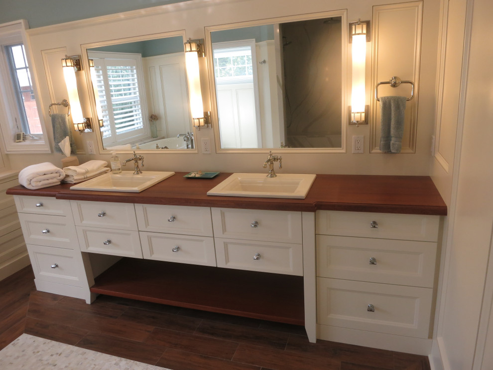 Photo of a large traditional ensuite bathroom in Other with recessed-panel cabinets, white cabinets, multi-coloured walls, a vessel sink, wooden worktops, brown floors, brown worktops, double sinks, a built in vanity unit, a coffered ceiling and wainscoting.
