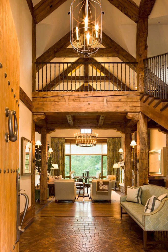 Expansive country foyer in Denver with white walls, medium hardwood floors, a single front door, a light wood front door and brown floor.