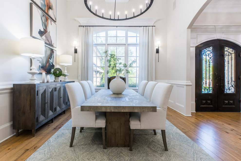 This is an example of an expansive transitional separate dining room in Atlanta with grey walls, bamboo floors, vaulted and decorative wall panelling.