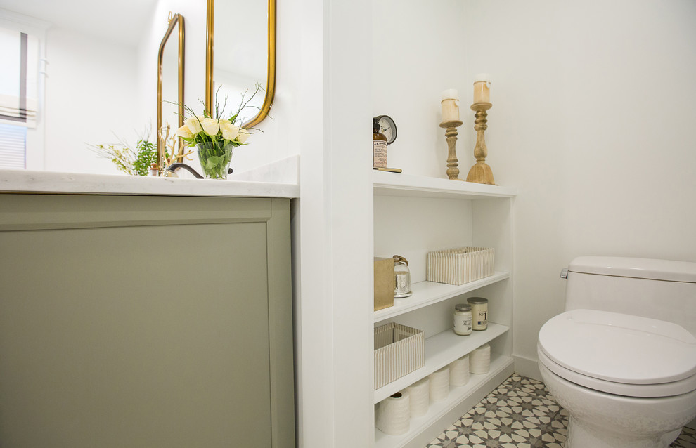 This is an example of a mid-sized country master bathroom in Los Angeles with louvered cabinets, grey cabinets, a freestanding tub, an alcove shower, a one-piece toilet, white tile, ceramic tile, white walls, cement tiles, an undermount sink, marble benchtops, grey floor and a hinged shower door.