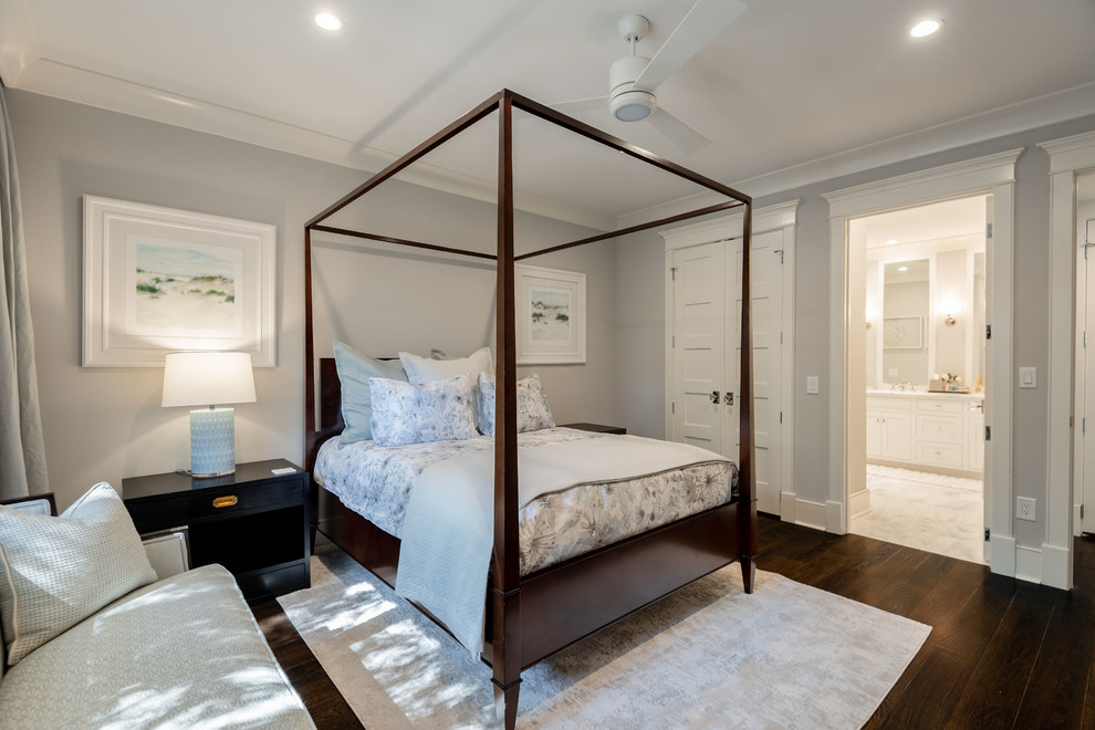 This is an example of a mid-sized traditional guest bedroom in Charleston with grey walls, dark hardwood floors and brown floor.