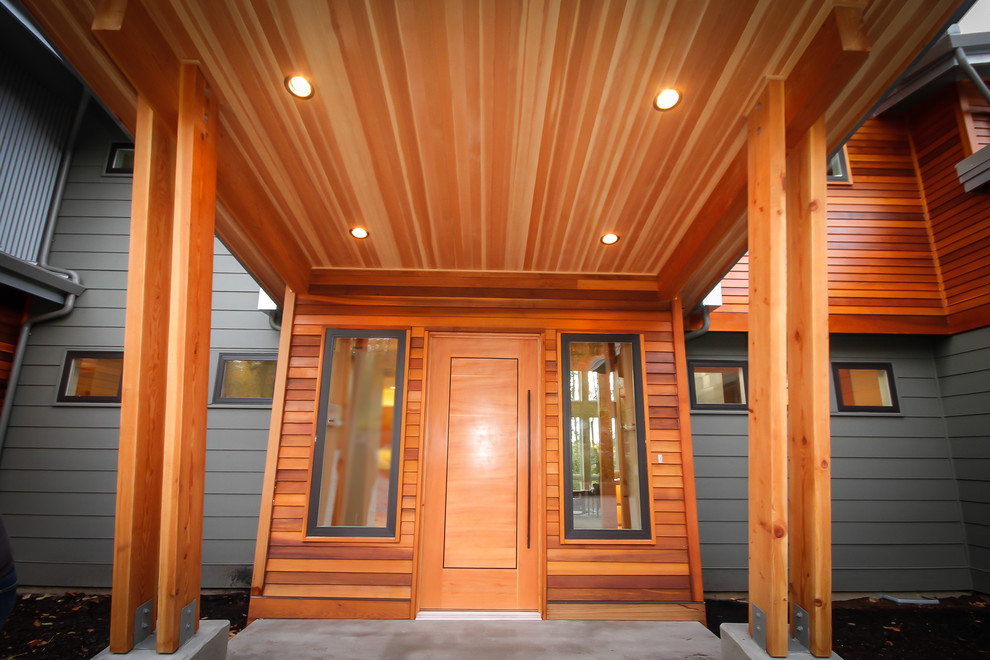 Photo of a large modern two-storey multi-coloured house exterior in Seattle with wood siding.