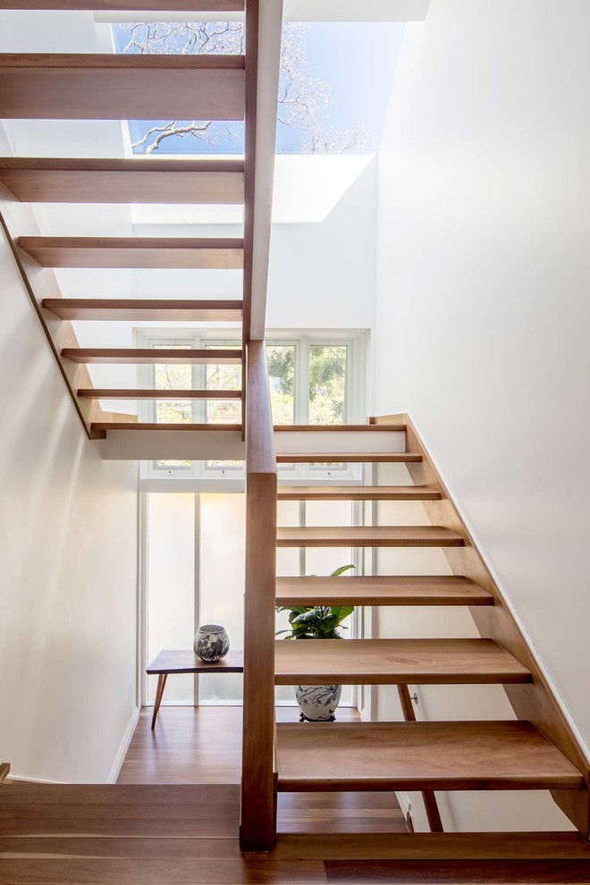 This is an example of a contemporary wood u-shaped staircase in Sydney with open risers.