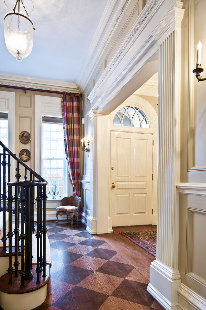 Design ideas for a traditional front door in New York with beige walls, a single front door, a white front door, brown floor and medium hardwood floors.