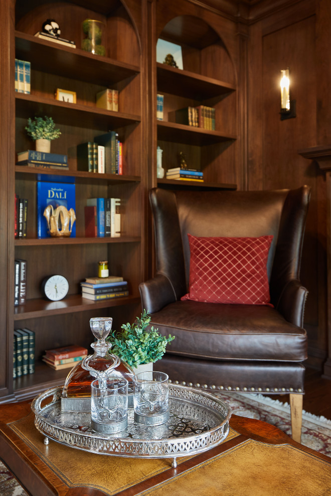 Inspiration for a small traditional home office in Grand Rapids with a library, brown walls, dark hardwood floors, a standard fireplace, a brick fireplace surround, brown floor, coffered and wood walls.