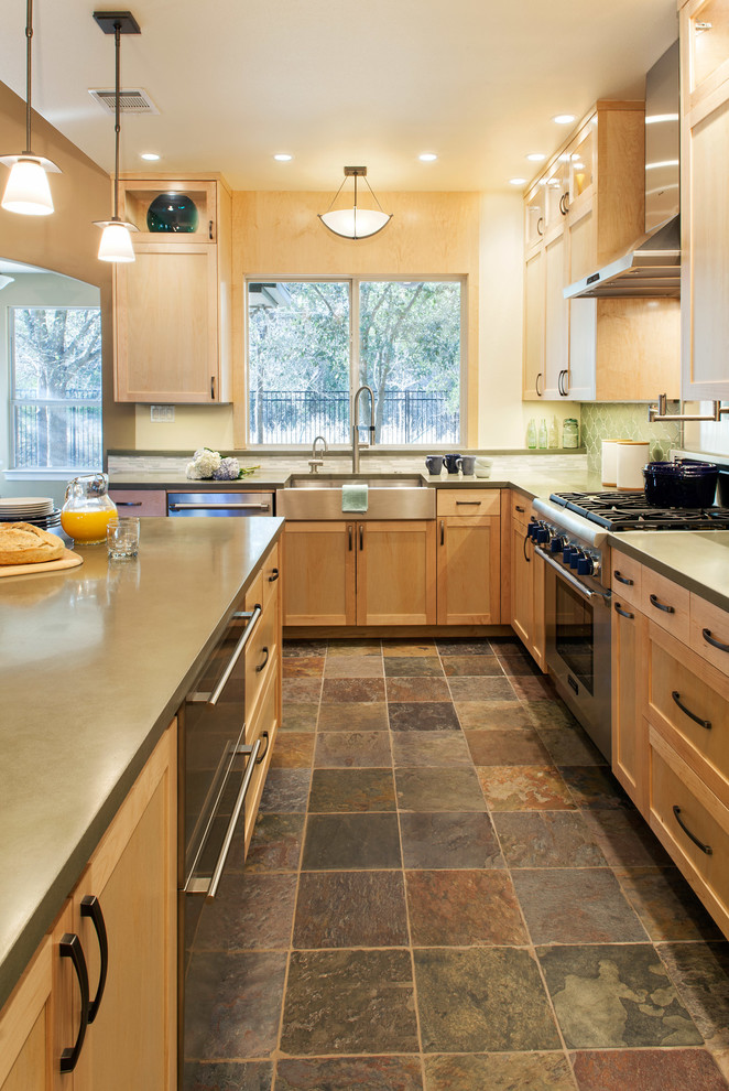 Inspiration for a mid-sized transitional l-shaped slate floor eat-in kitchen remodel in Austin with an undermount sink, recessed-panel cabinets, light wood cabinets, green backsplash, stainless steel appliances and an island