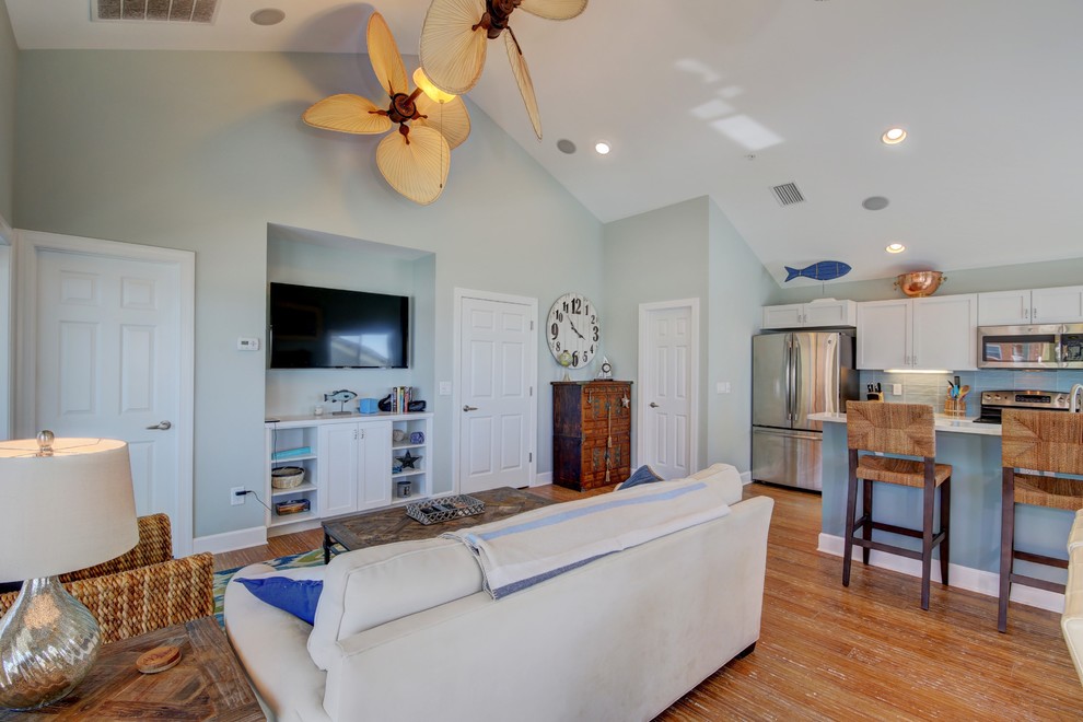 Mid-sized beach style open concept family room in Tampa with blue walls, bamboo floors, no fireplace and a wall-mounted tv.