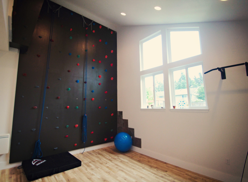 Inspiration for a large traditional home climbing wall in Seattle with white walls and light hardwood floors.