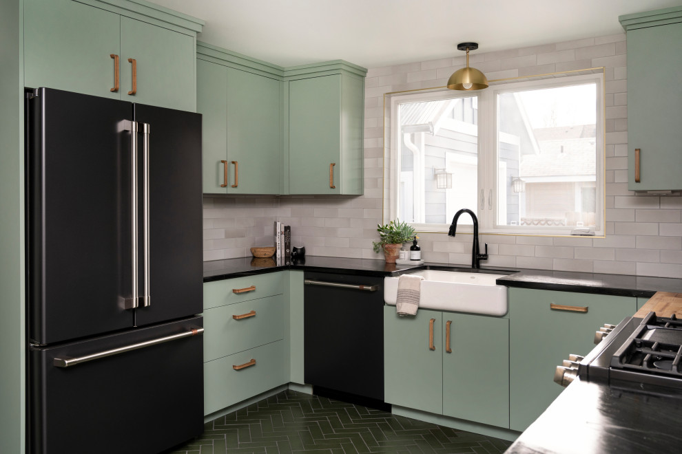Inspiration for a large eclectic u-shaped eat-in kitchen in Boise with green cabinets, white splashback, brick splashback, brick floors, green floor and black benchtop.