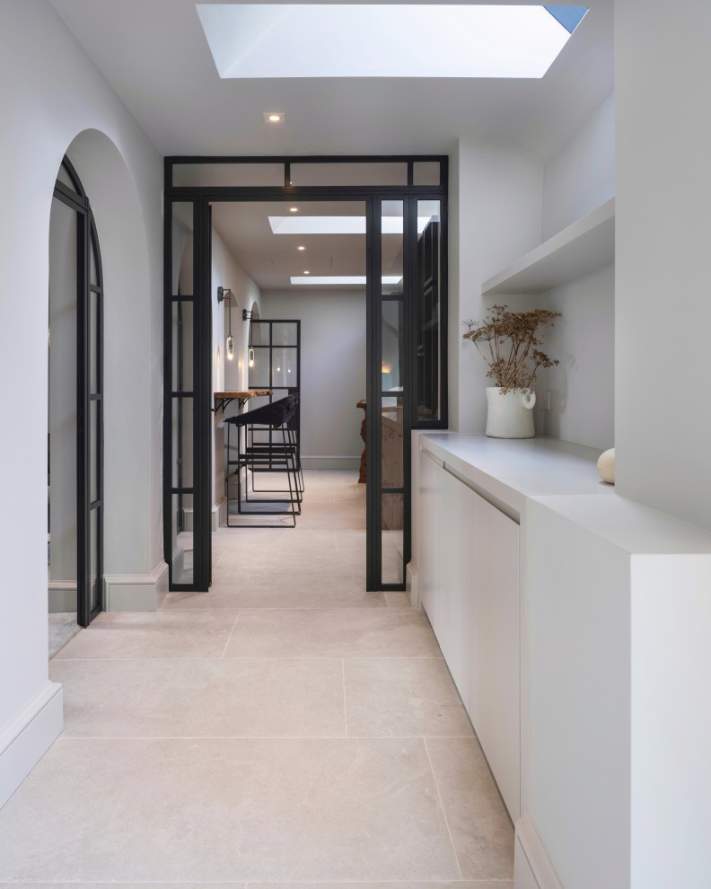 Inspiration for a large contemporary hallway in West Midlands with ceramic floors and white floor.