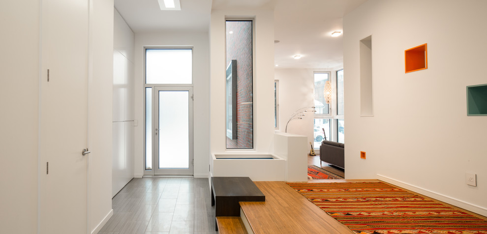 Design ideas for a modern entryway in Ottawa with white walls.