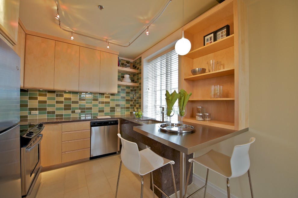 Contemporary kitchen in Oklahoma City with stainless steel appliances, multi-coloured splashback, flat-panel cabinets and light wood cabinets.