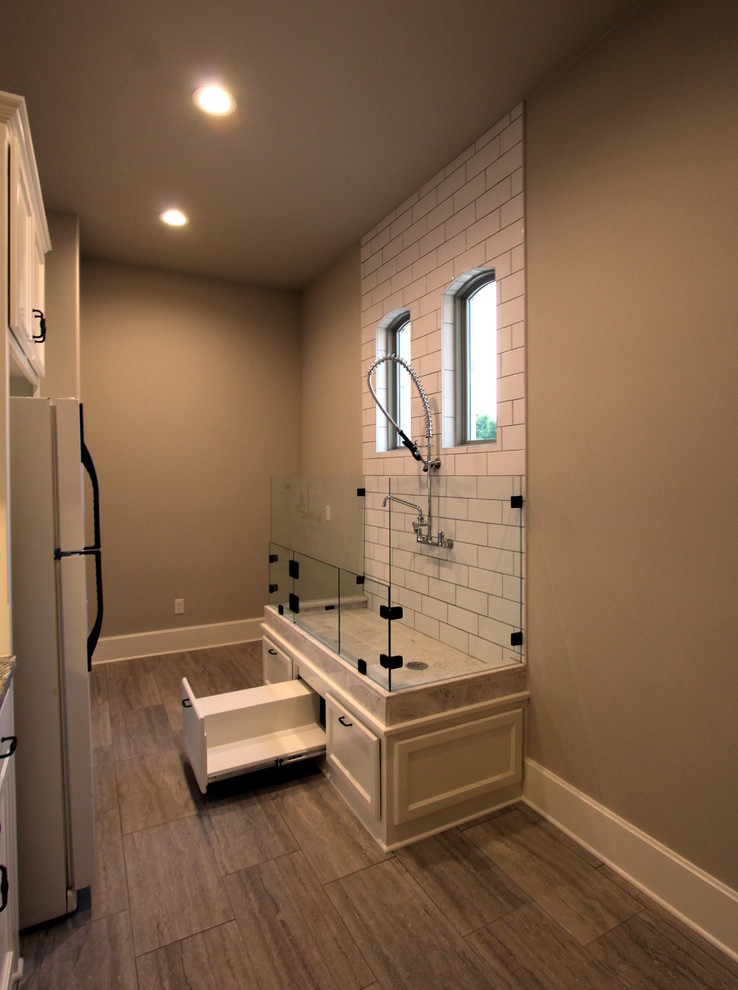 Large tuscan laminate floor and beige floor entryway photo in Austin with beige walls and a white front door