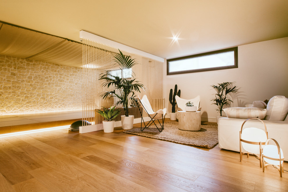 Mediterranean living room in Barcelona with light hardwood floors.