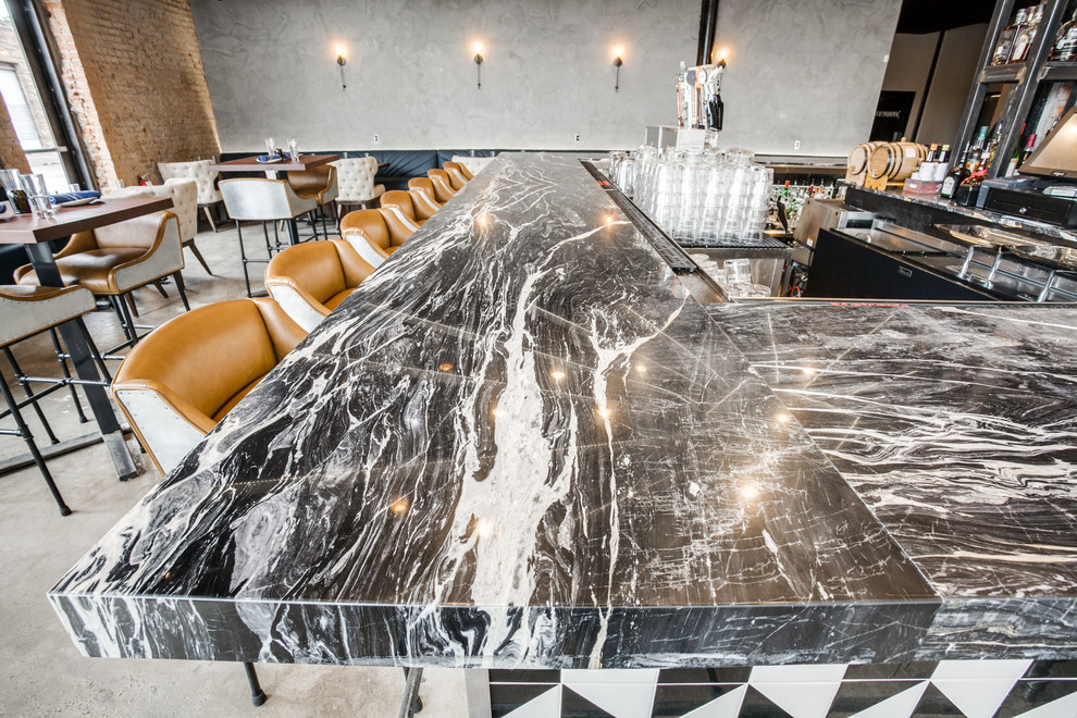 Inspiration for a huge contemporary l-shaped concrete floor seated home bar remodel in Dallas with no sink, marble countertops and brick backsplash