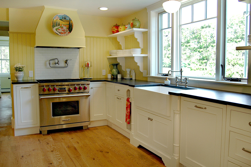 Mid-sized traditional l-shaped separate kitchen in Boston with an undermount sink, shaker cabinets, white cabinets, granite benchtops, ceramic splashback, stainless steel appliances, medium hardwood floors, with island and yellow splashback.