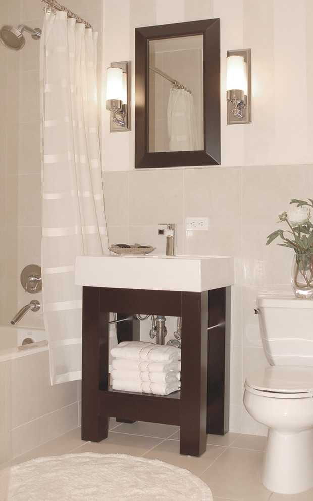 This is an example of a contemporary bathroom in New York with an alcove tub, gray tile and a console sink.