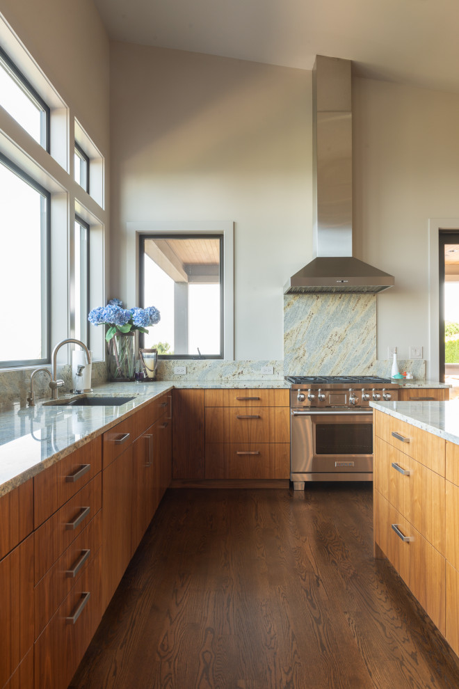 Contemporary l-shaped kitchen in Seattle with an undermount sink, flat-panel cabinets, medium wood cabinets, grey splashback, stone slab splashback, stainless steel appliances, dark hardwood floors, with island, brown floor and grey benchtop.