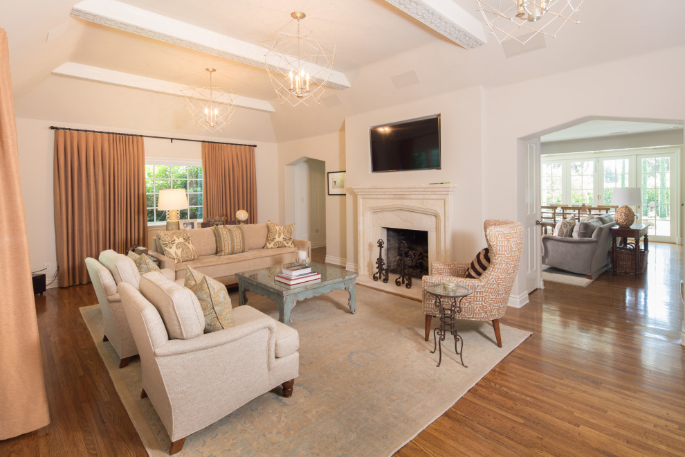 Photo of a large transitional formal open concept living room in Los Angeles with white walls, medium hardwood floors, a standard fireplace, a stone fireplace surround and a wall-mounted tv.