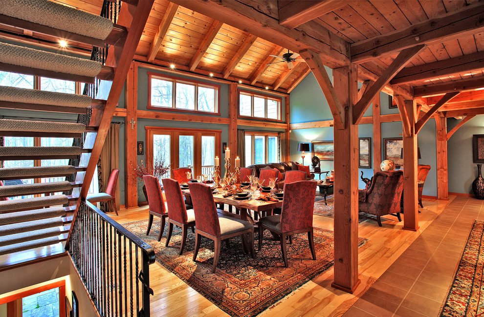 Example of a mid-sized mountain style medium tone wood floor and brown floor great room design in Baltimore with blue walls