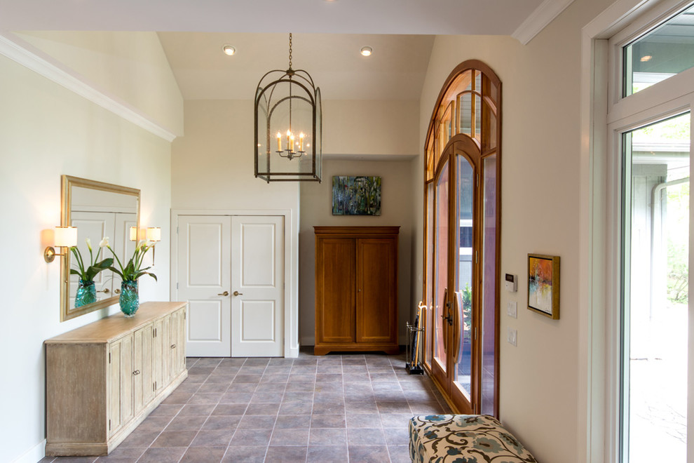 This is an example of a large traditional foyer in Toronto with white walls, a double front door and a medium wood front door.