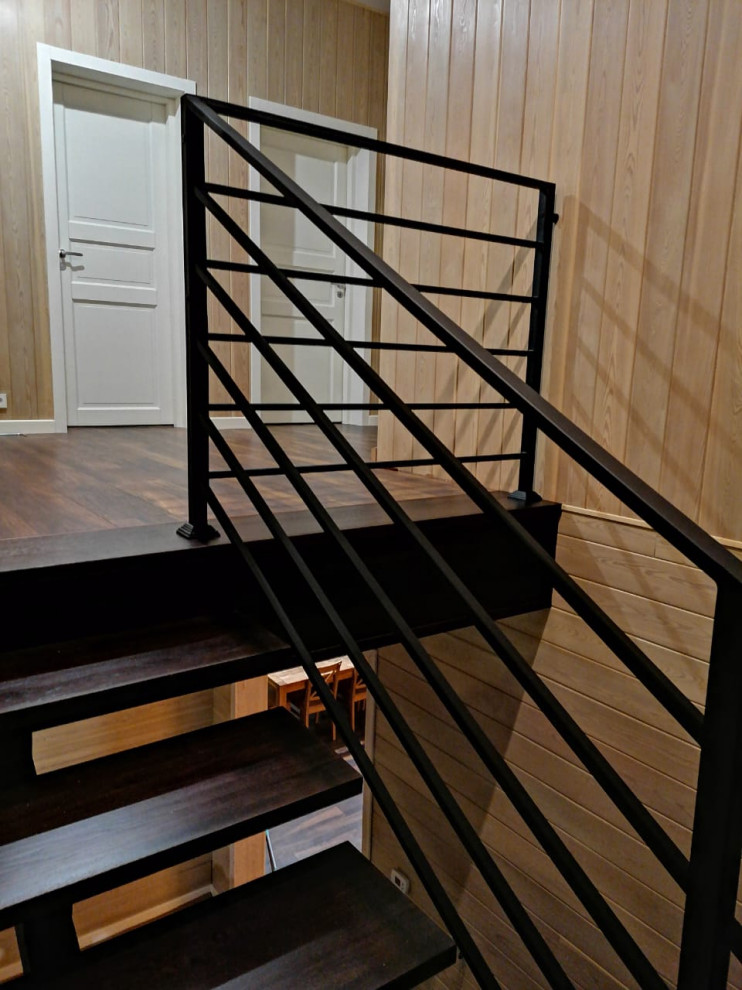 Стильный дизайн: п-образная лестница среднего размера в стиле лофт с деревянными ступенями, металлическими перилами и деревянными стенами - последний тренд