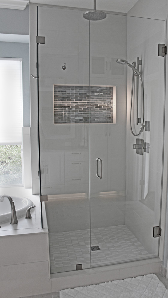 Drop-in bathtub - large transitional master beige tile and porcelain tile porcelain tile and beige floor drop-in bathtub idea in Austin with shaker cabinets, white cabinets, quartz countertops, an undermount sink, blue walls, a hinged shower door, beige countertops and a two-piece toilet