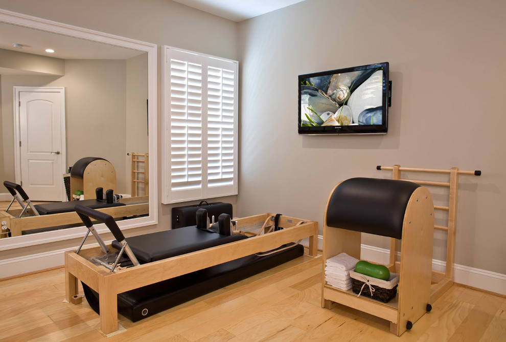 Inspiration for a traditional home gym in DC Metro with beige walls and light hardwood floors.