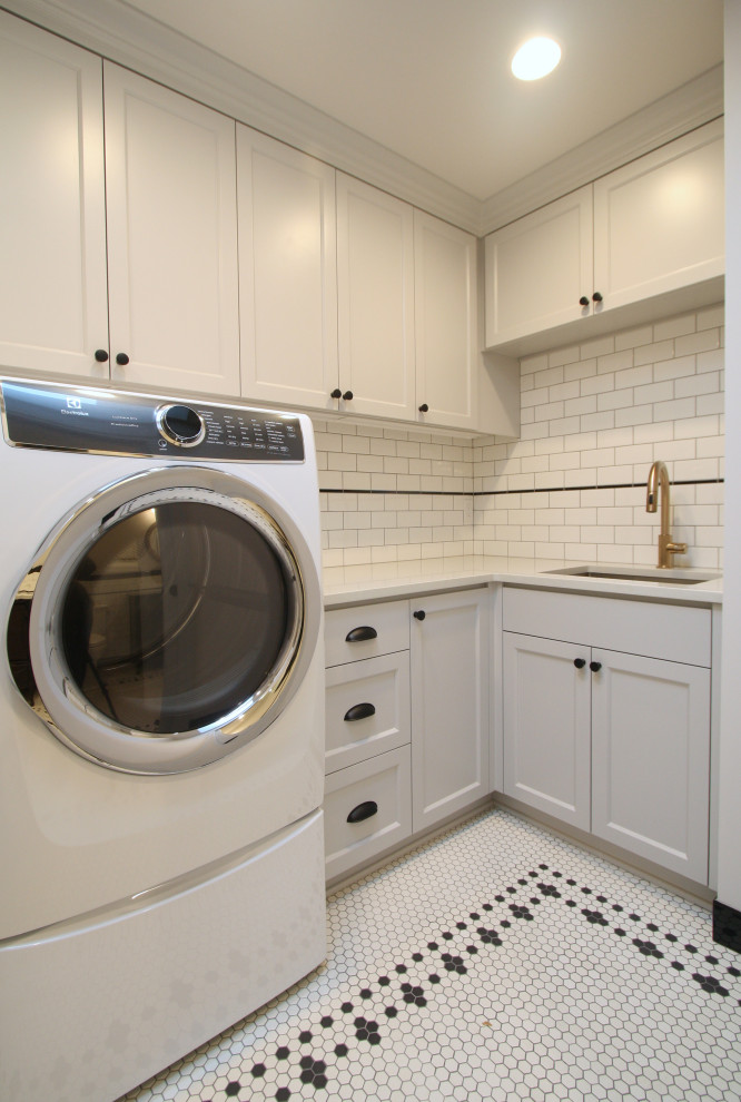 Small traditional l-shaped dedicated laundry room in Portland with an undermount sink, shaker cabinets, grey cabinets, quartz benchtops, white splashback, subway tile splashback, white walls, porcelain floors, a side-by-side washer and dryer, white floor and white benchtop.