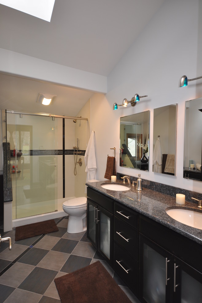 Example of a large trendy kids' white tile and porcelain tile porcelain tile corner shower design in Other with an undermount sink, glass-front cabinets, black cabinets, granite countertops, a two-piece toilet and white walls