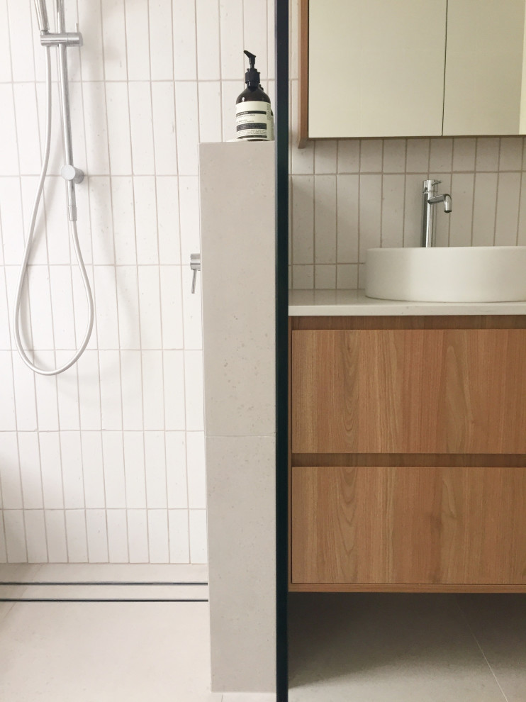 Photo of a small contemporary wet room bathroom in Perth with a built-in bath, white tiles, porcelain flooring, a vessel sink, engineered stone worktops, grey floors, an open shower, a single sink and a floating vanity unit.