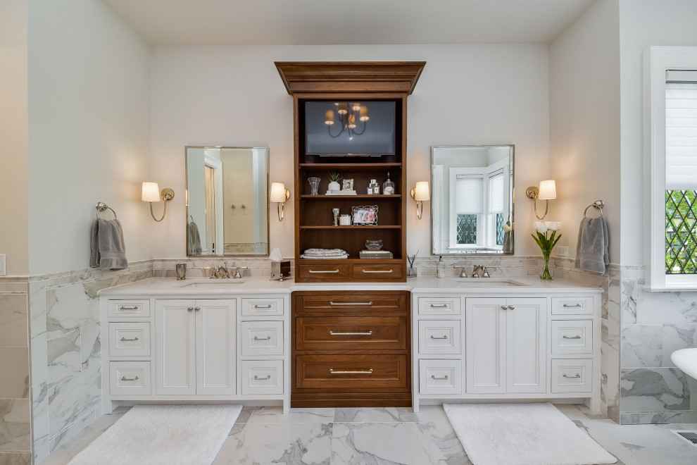This is an example of a large traditional master bathroom in Chicago with white cabinets, porcelain tile, white walls, marble floors, an undermount sink, engineered quartz benchtops, white floor, white benchtops, a double vanity, a built-in vanity, decorative wall panelling, recessed-panel cabinets and gray tile.