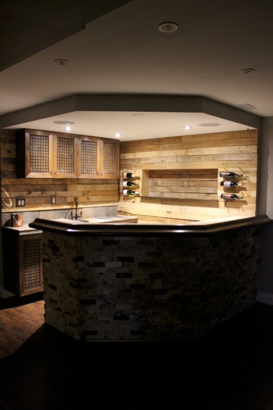 Design ideas for a large eclectic u-shaped wet bar in Toronto with a drop-in sink, brown cabinets, tile benchtops, brown splashback, porcelain floors and timber splashback.