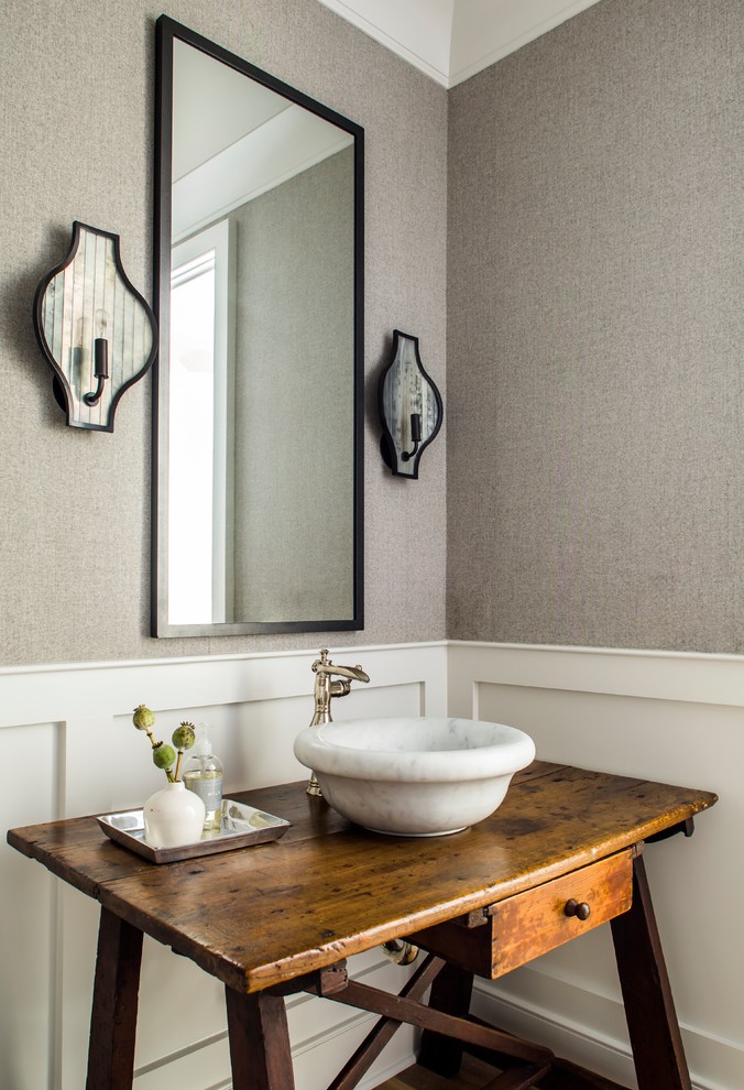 Beach style powder room in Atlanta with furniture-like cabinets, medium wood cabinets, grey walls, a vessel sink and wood benchtops.