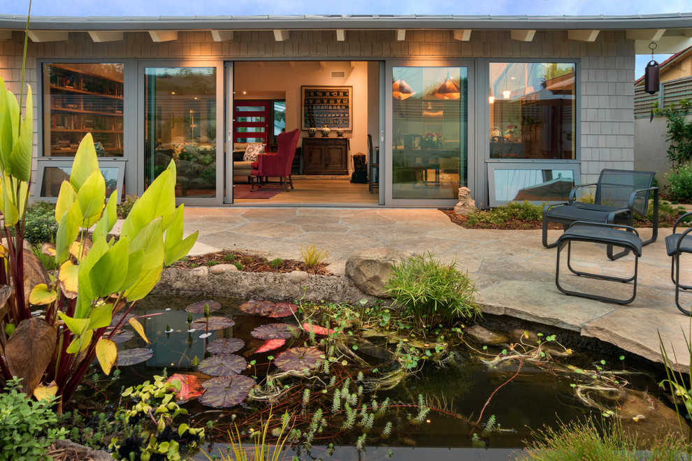 Mid-sized modern backyard patio in Santa Barbara with a water feature, no cover and natural stone pavers.