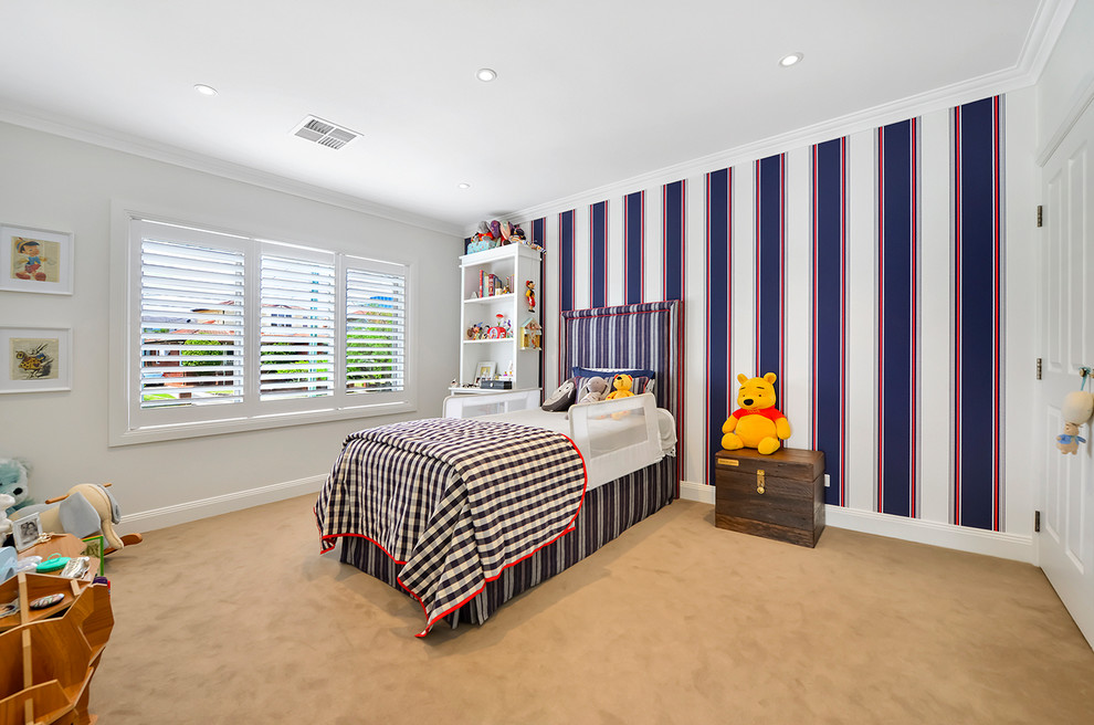 Photo of a large contemporary kids' bedroom for kids 4-10 years old and boys in Sydney with beige walls, carpet and brown floor.