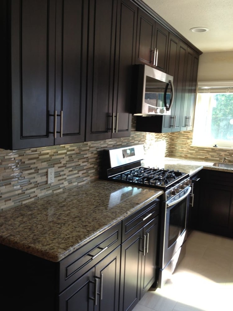 Mid-sized transitional u-shaped open concept kitchen photo in San Francisco with an undermount sink, raised-panel cabinets, black cabinets, granite countertops, gray backsplash, matchstick tile backsplash, stainless steel appliances, a peninsula and gray countertops