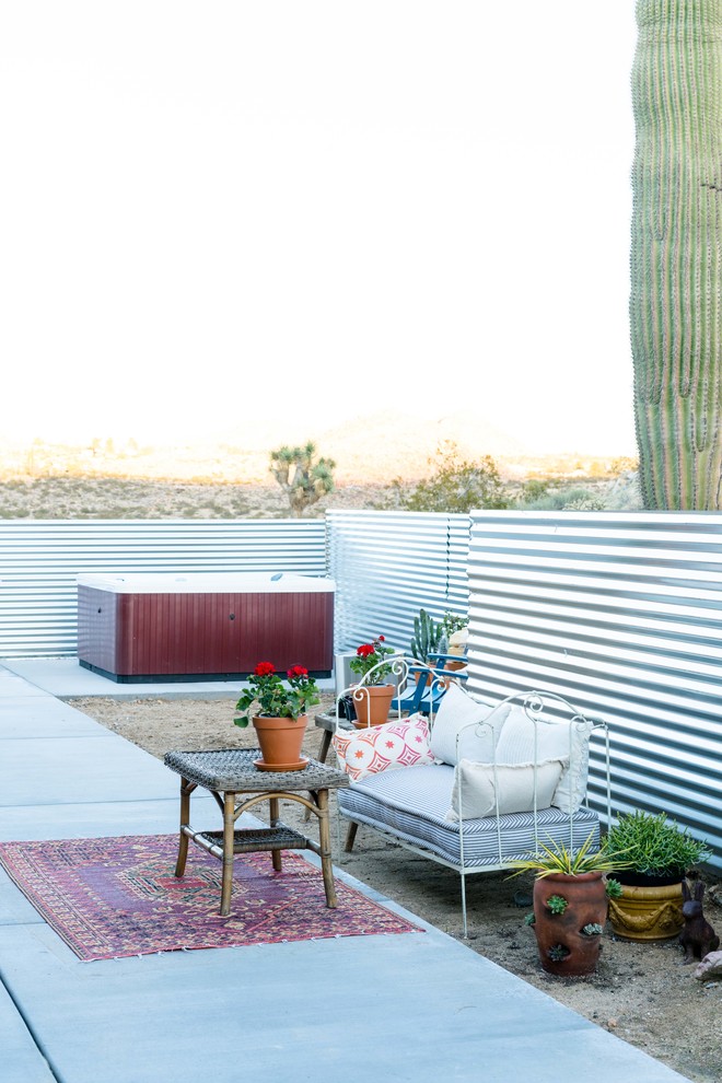 Inspiration for a large eclectic backyard patio in Other with a container garden and concrete slab.