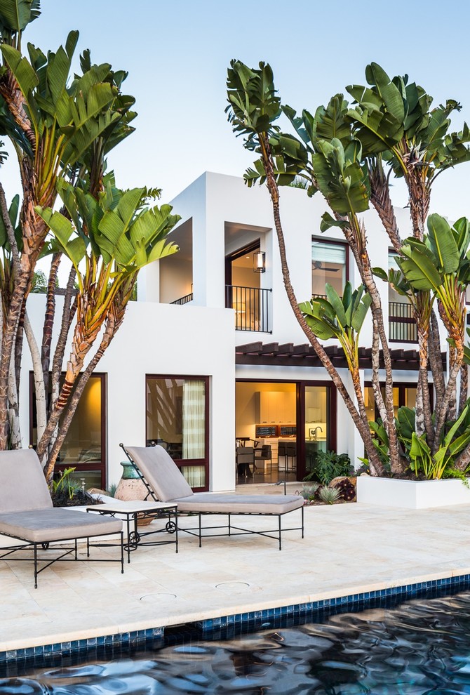 Photo of a contemporary two-storey stucco white exterior in Santa Barbara with a flat roof.