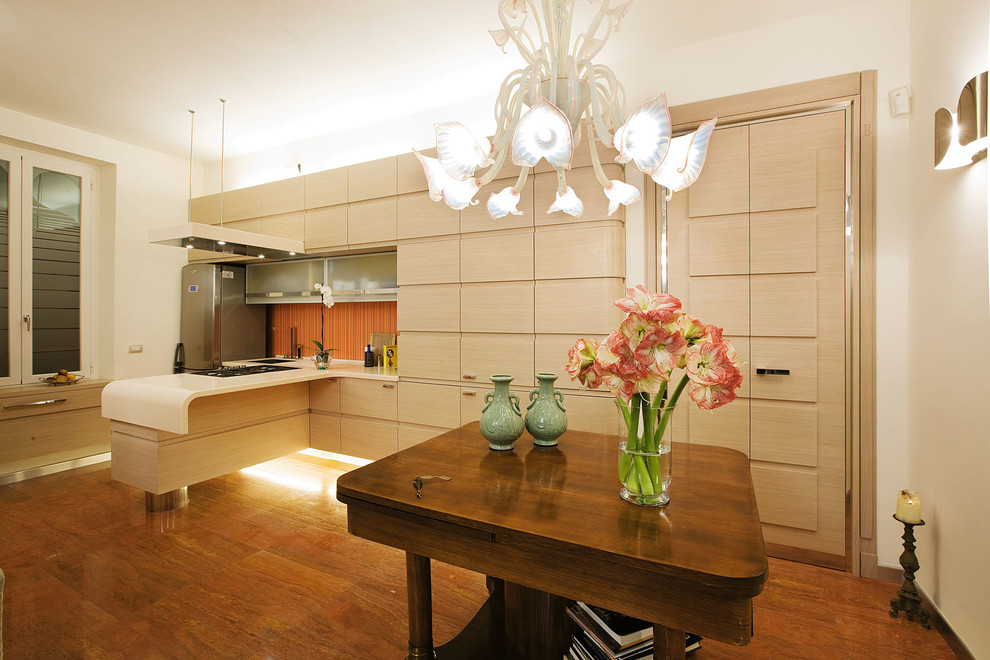 Photo of a large contemporary single-wall eat-in kitchen in Other with flat-panel cabinets, light wood cabinets, stainless steel appliances and a peninsula.